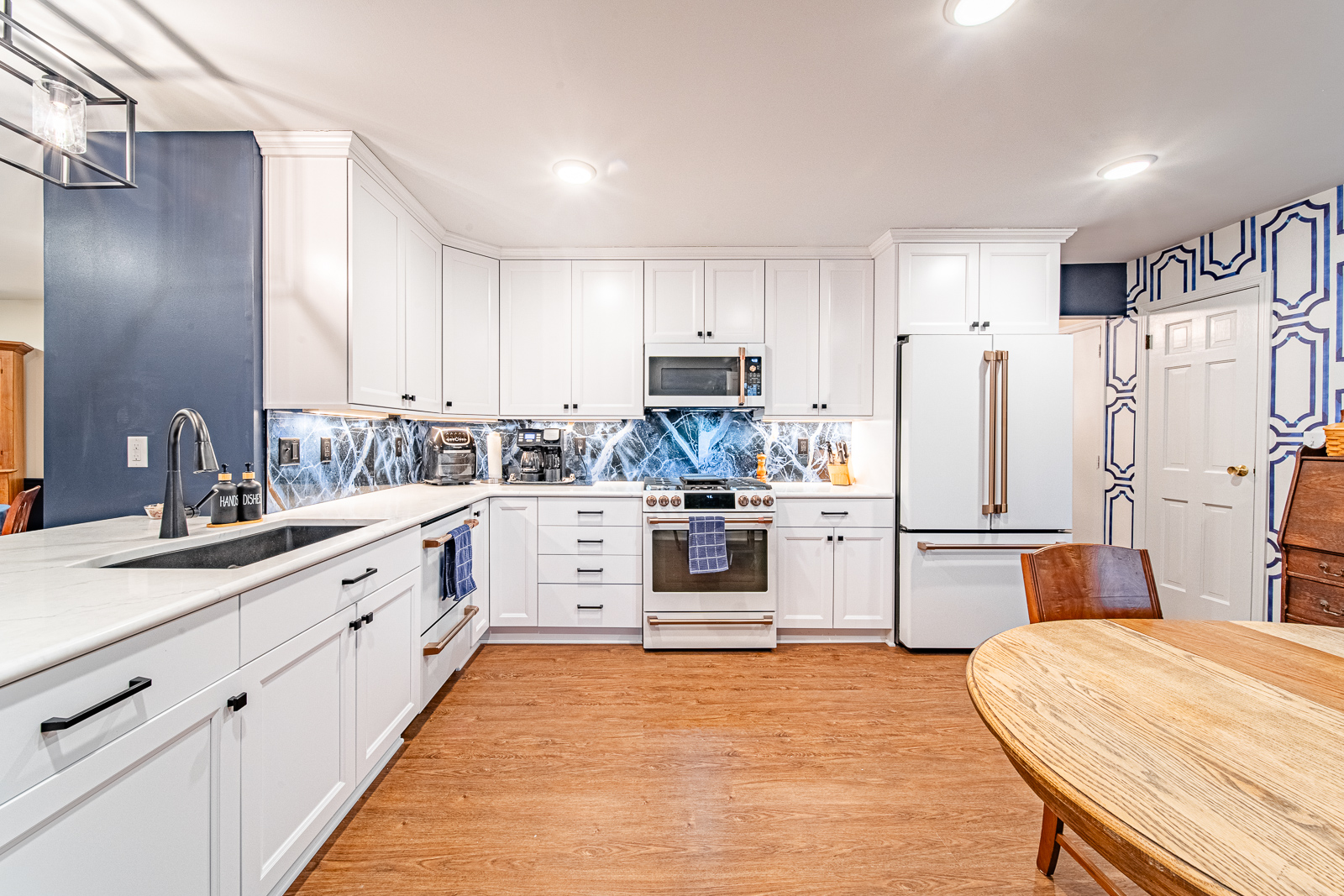 Explore a Lafayette home's multi-space renovation, designed for accessibility with a wheelchair-friendly kitchen, bathrooms, and a leveled family room, all infused with a charming blue theme.