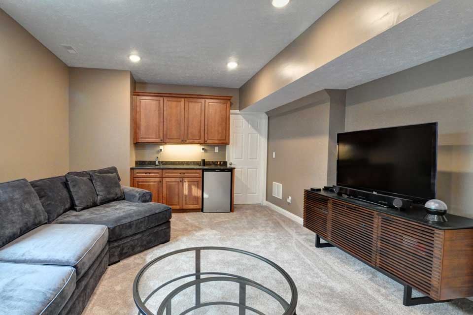 An unfinished basement remodel including a bathroom and exercise room by Riverside Construction in Lafayette, Indiana.