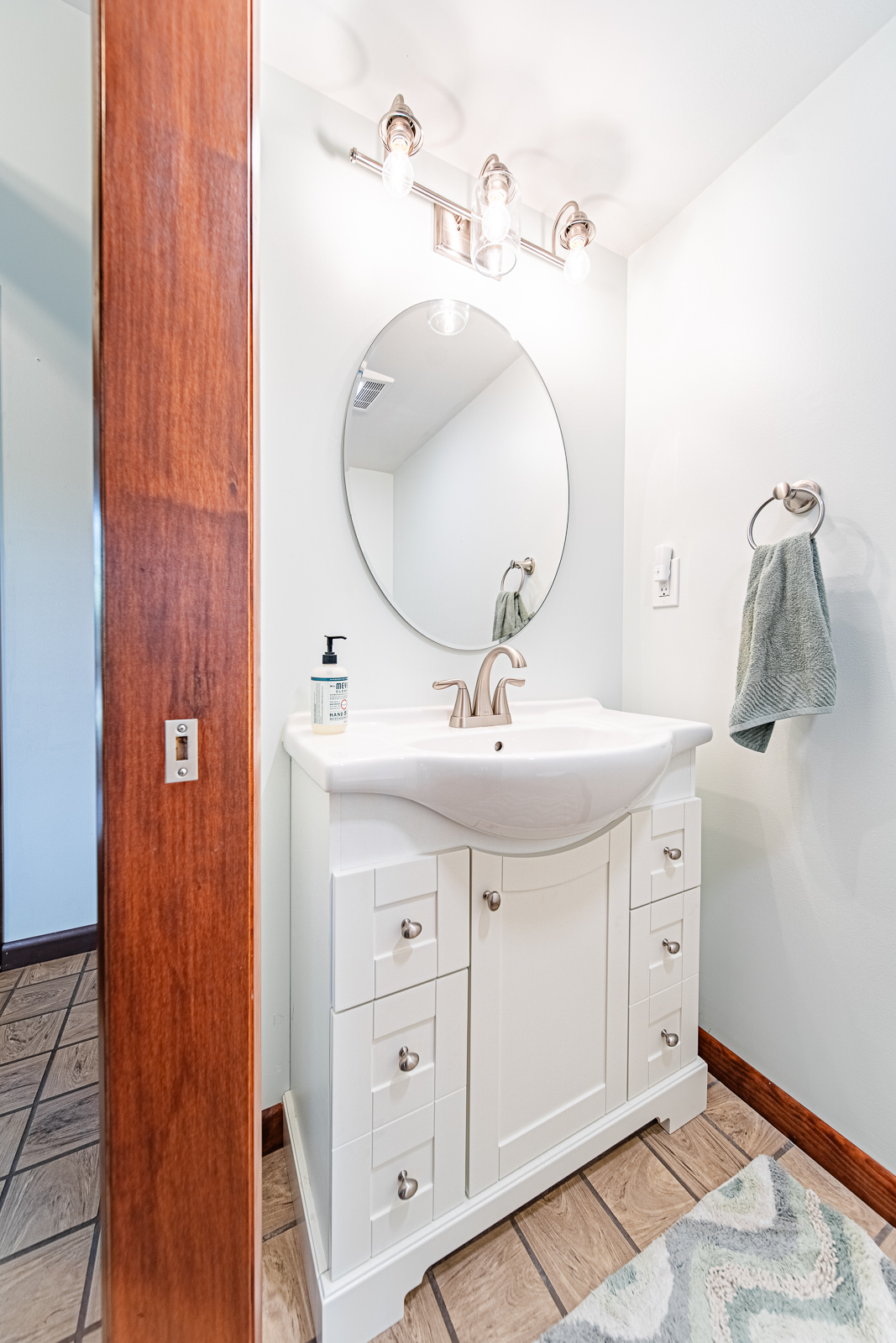 Discover the addition of a new bathroom to a spacious entryway in Battle Ground, featuring a pedestal sink, comfort-height toilet, and brushed nickel fixtures.