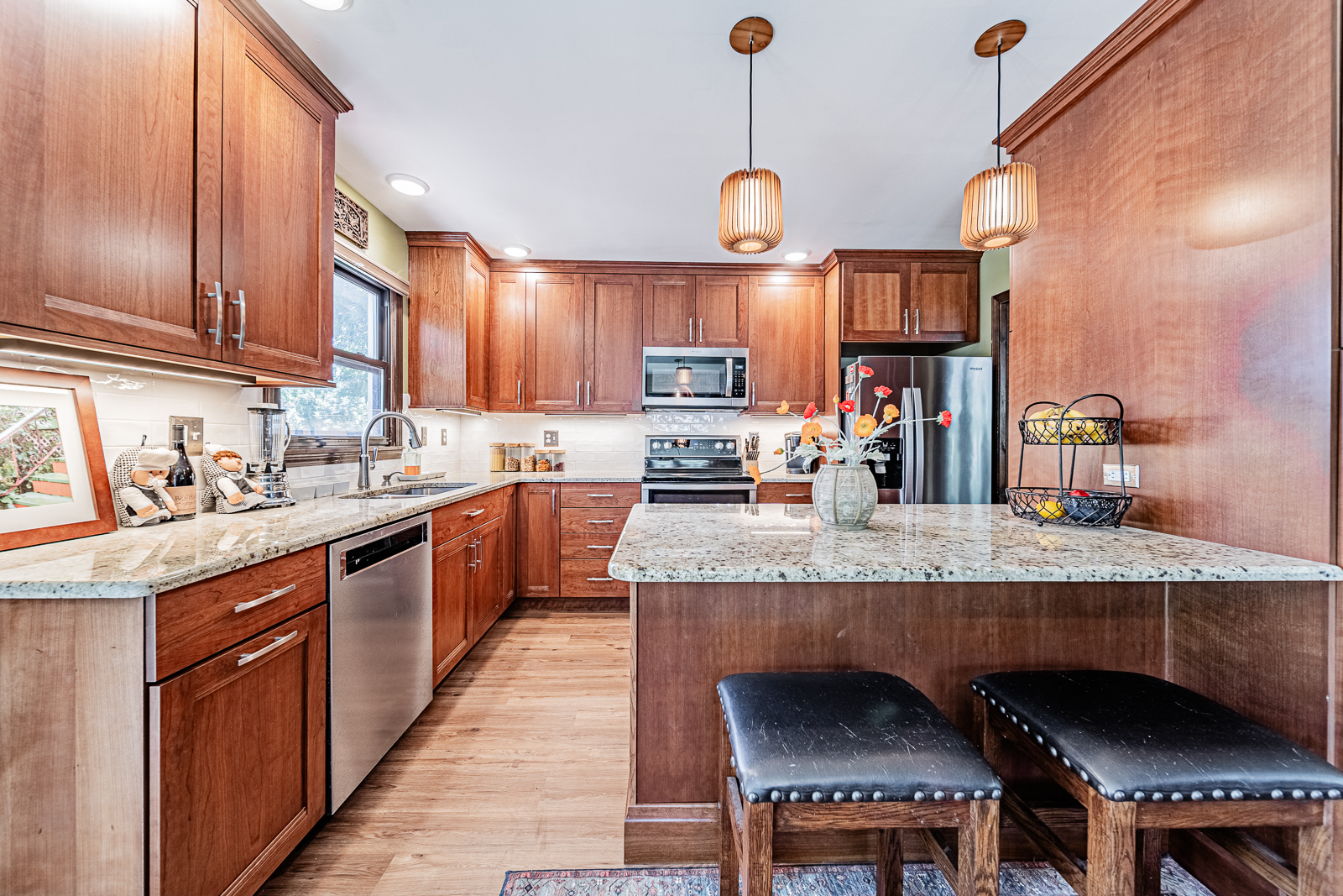 Explore the transformation of a Lafayette kitchen with updated cabinets, luxury vinyl flooring, and quartz countertops, blending warmth and modern functionality.