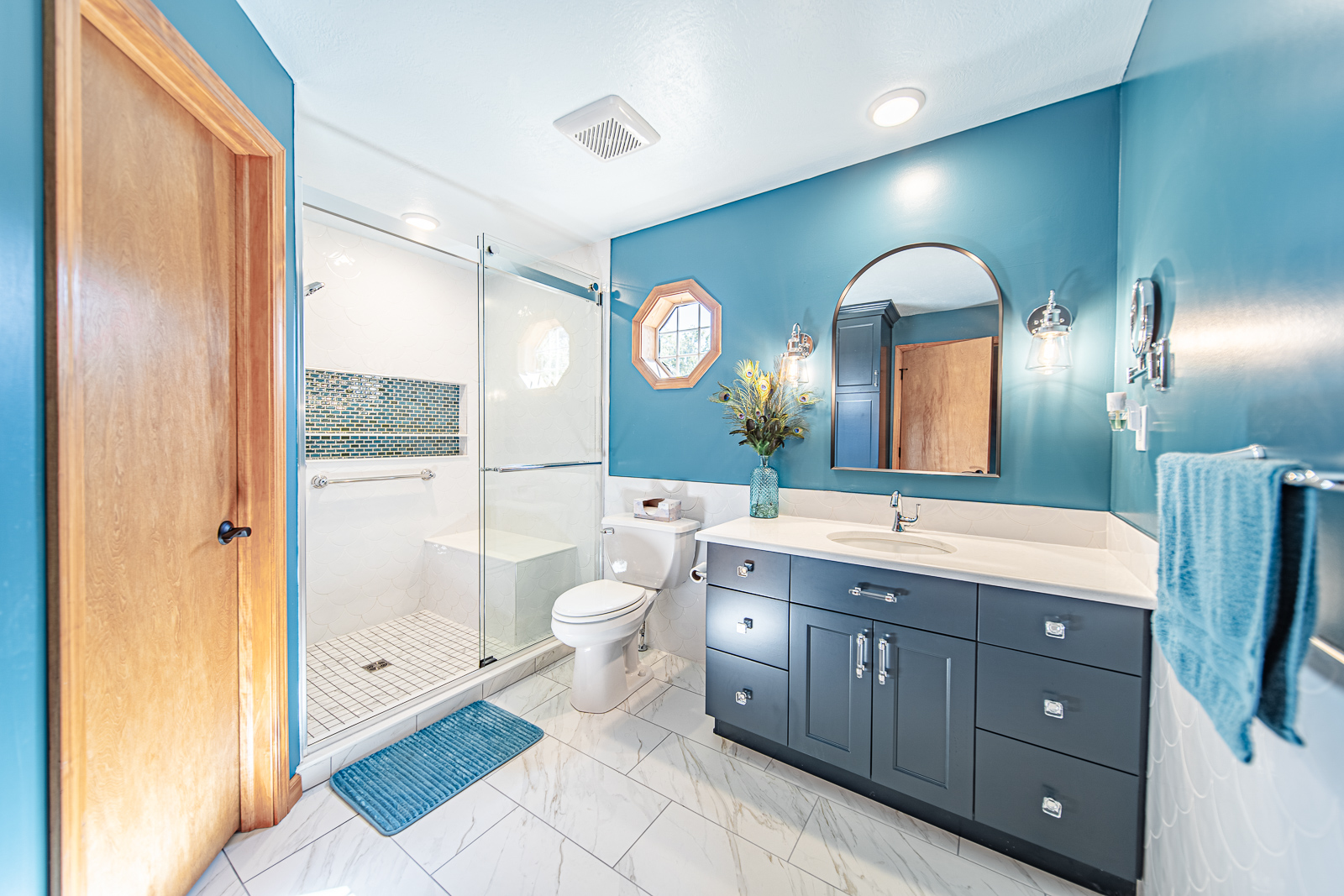 Transforming an outdated primary bathroom with a larger shower, heated tile floors, and custom storage solutions into a modern, spa-inspired retreat.