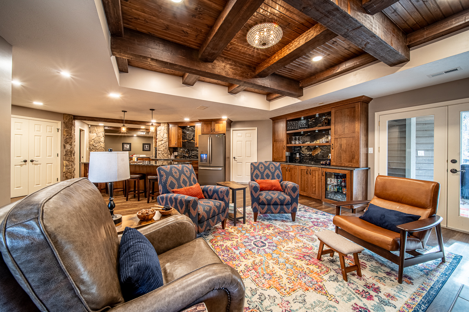 Ripple Creek Drive basement sitting area with a focus on wooden beams and fireplace.