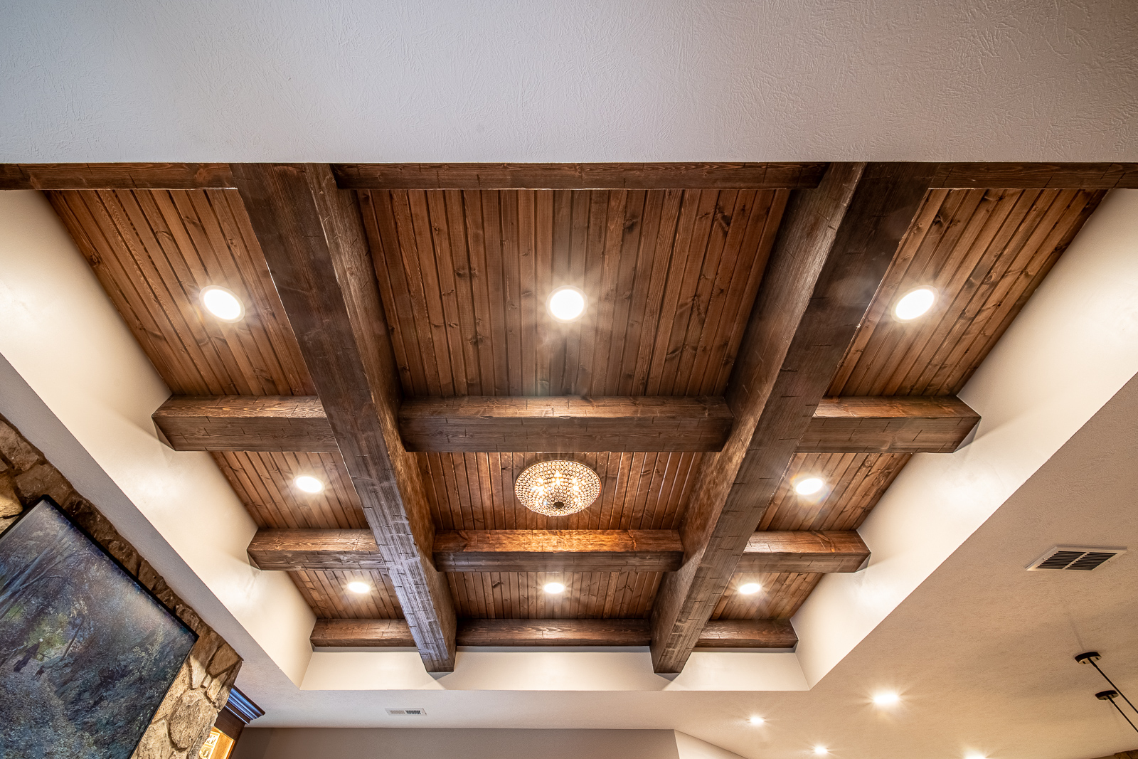 Distinctive wood beam accents in a tray ceiling in the Ripple Creek Drive basement.