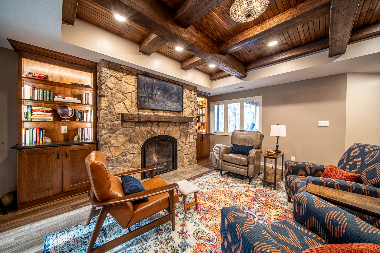 Inviting basement sitting area with elegant fireplace and rustic design on Ripple Creek Drive.