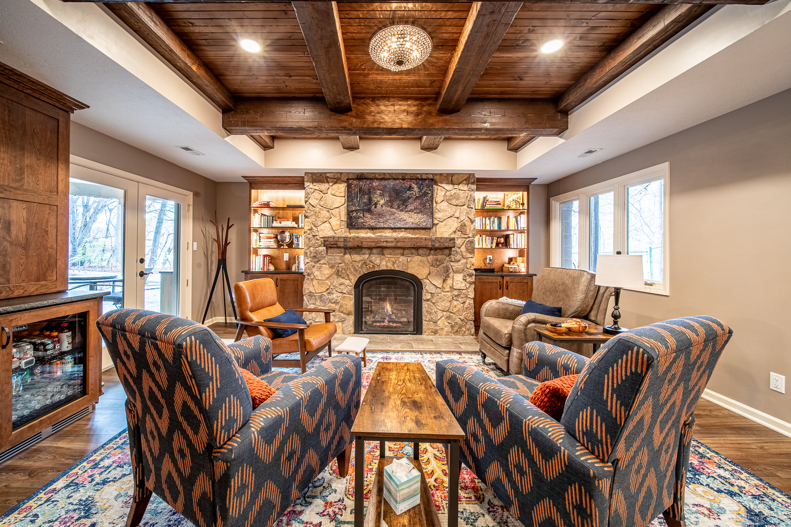 Stylish sitting area showcasing tray ceiling with wood beams in Ripple Creek Drive basement.