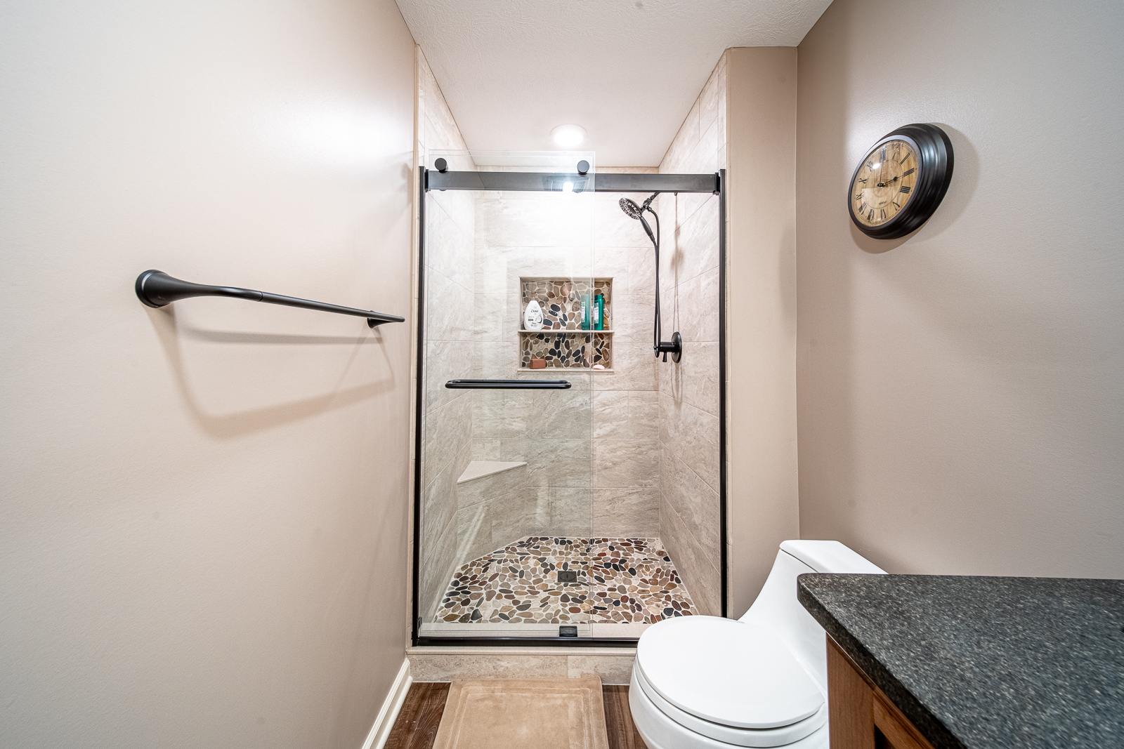 Elegant walk-in shower in the full bathroom of Ripple Creek Drive basement renovation.