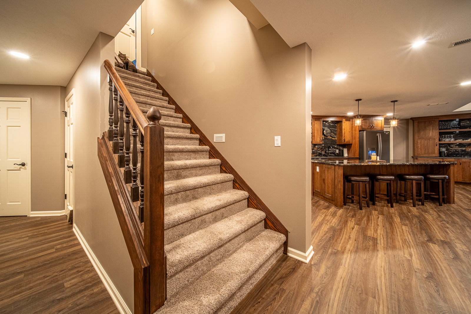 Wooden staircase with stylish railing in Ripple Creek Drive basement renovation.