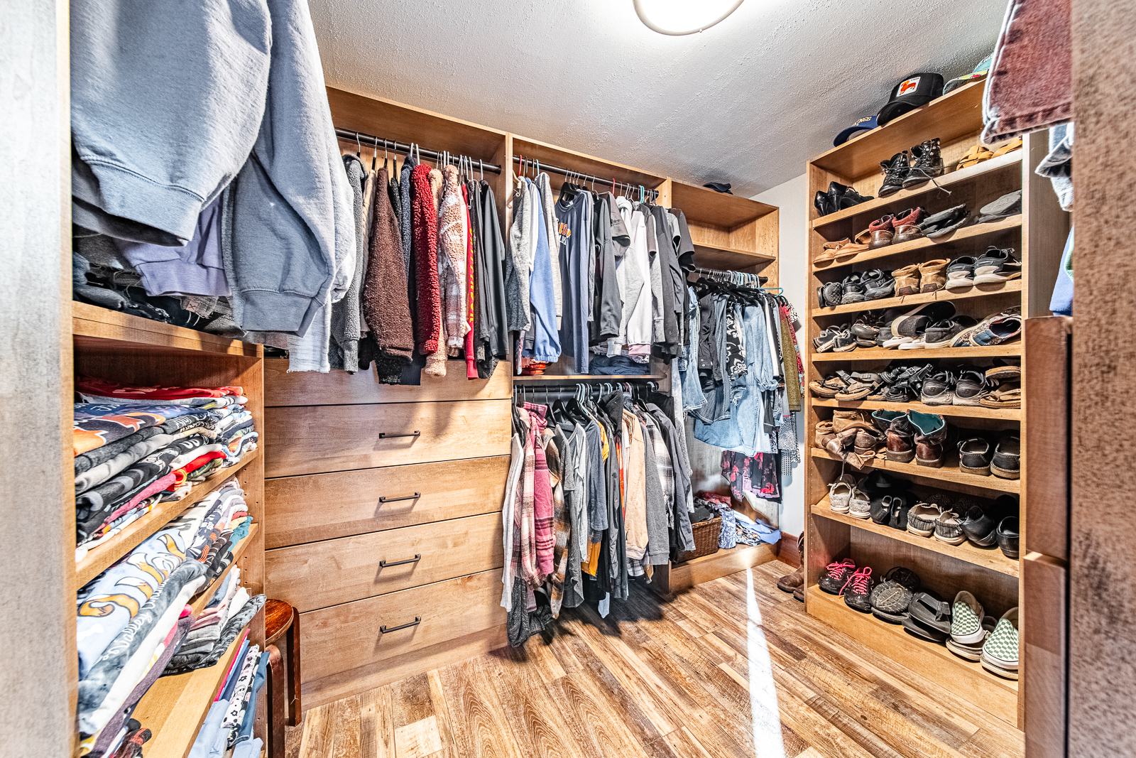 Innovative custom closet design in Lafayette home's master bedroom for optimal organization.