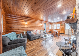 Lafayette family room with wood ceiling and log siding, exuding rustic charm.