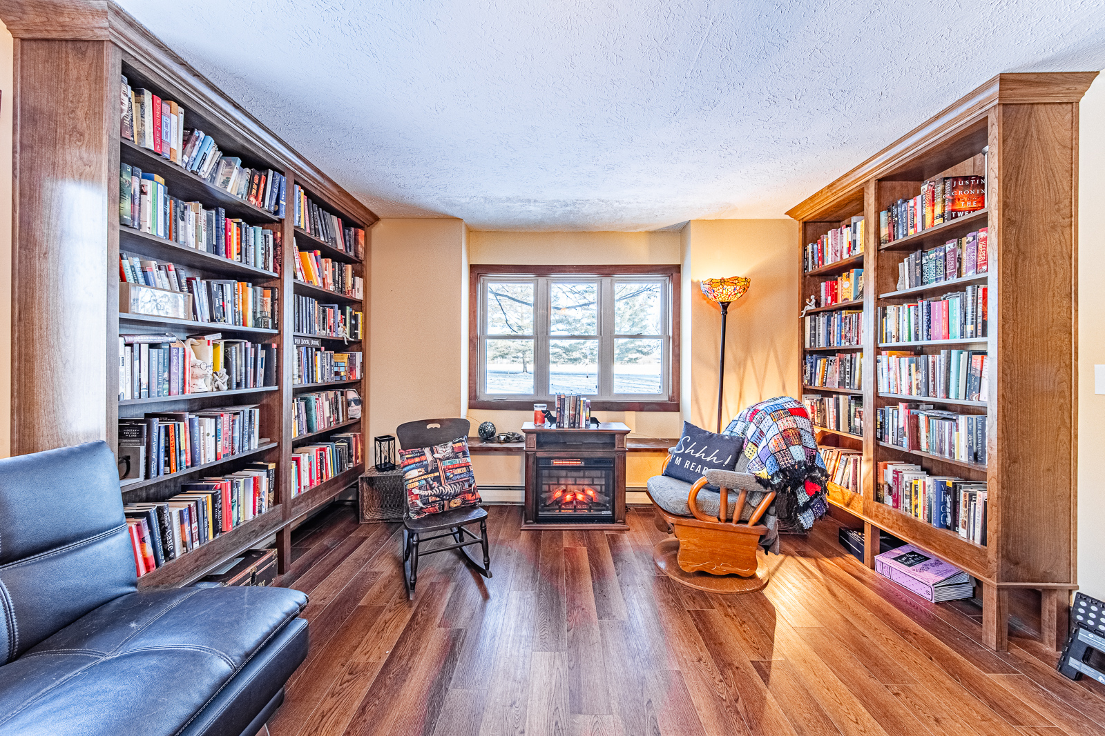 Lafayette home's living room elegantly transformed into a serene mini library space.