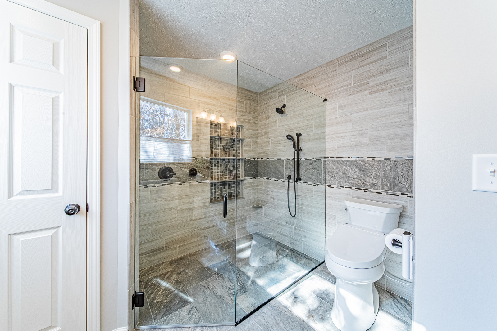 Well-designed shower and toilet area in Lafayette bathroom remodel, optimized for accessibility.
