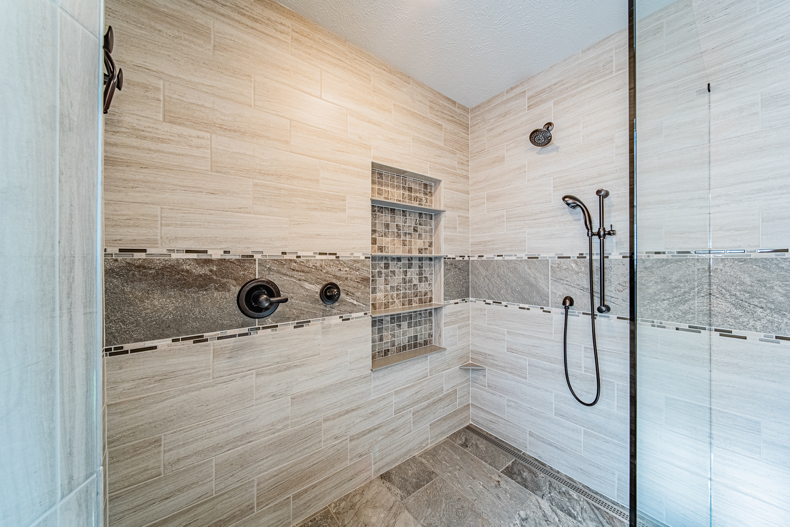 Modern shower with accessibility features in a Lafayette home's bathroom renovation.