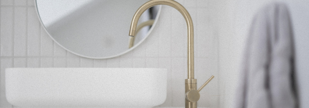 2024 Lafayette design trend of brushed brass faucet against natural wood grain cabinets in bathroom