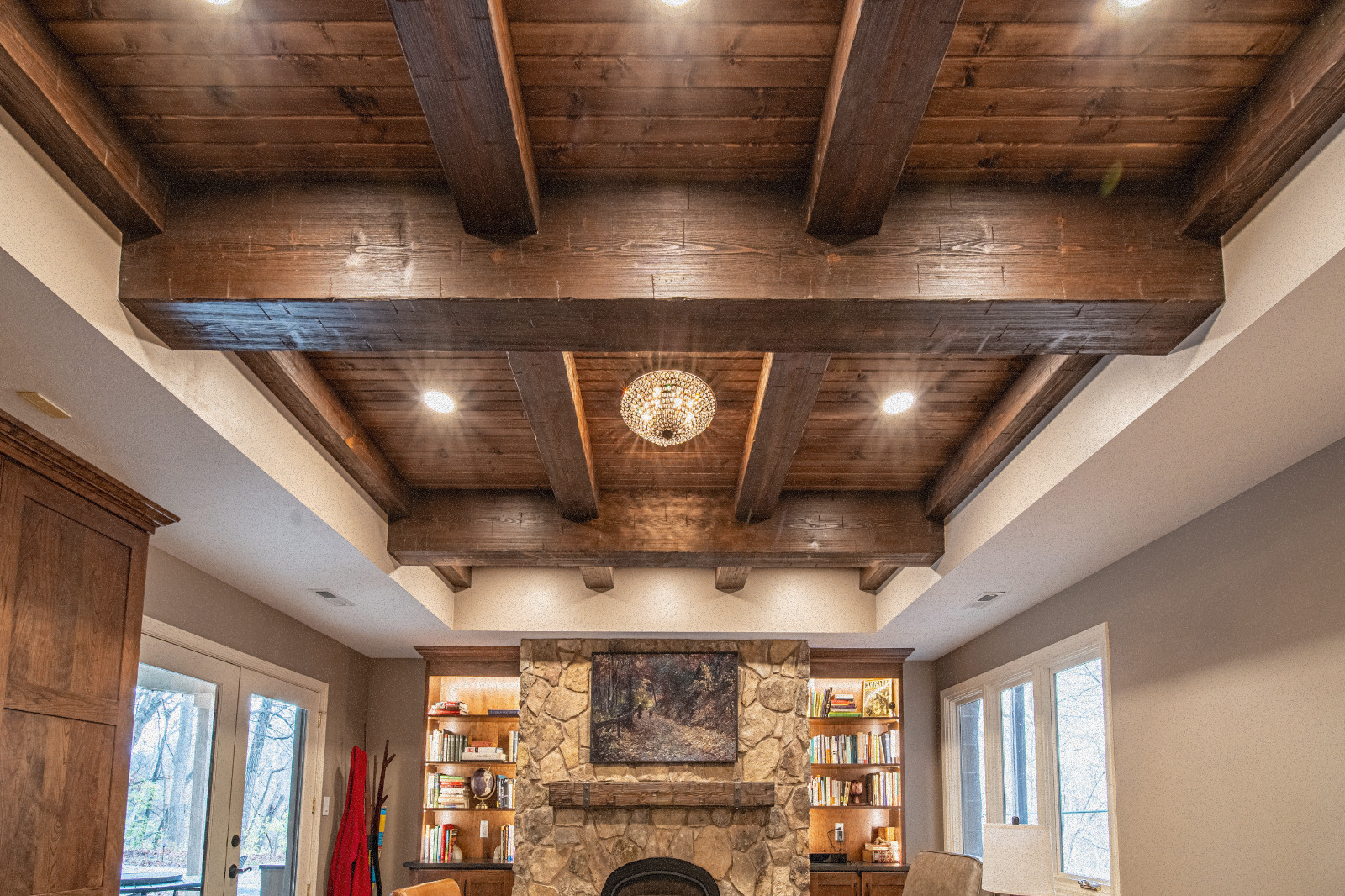 Cozy basement featuring a natural wood beam ceiling in Lafayette, by Riverside Construction